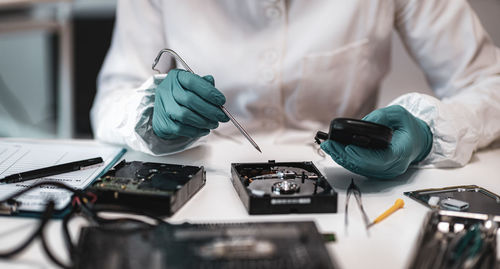Close-up of man working on hard disk drive