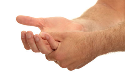 Close-up of hands against white background