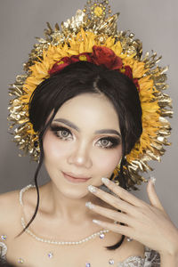 Close-up portrait of young woman with balinese traditional wedding