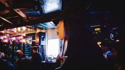 Side view of woman standing in restaurant