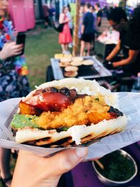 Close-up of hand holding burger