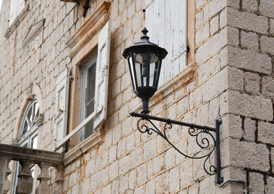Old vintage forgedlantern on stone wall of an old building