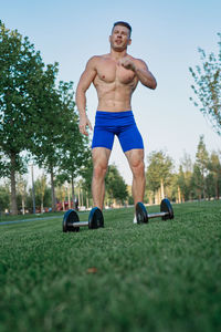 Full length of young man sitting in park