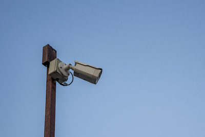 Low angle view of camera against sky