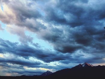 Silhouette mountains against dramatic sky