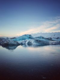 Scenic view of lake against sky during winter