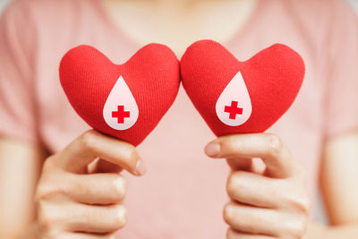 Close-up of woman holding heart shape with hands