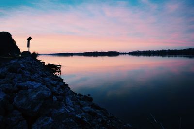 Scenic view of lake against cloudy sky