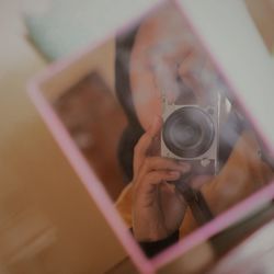 Close-up of woman photographing camera