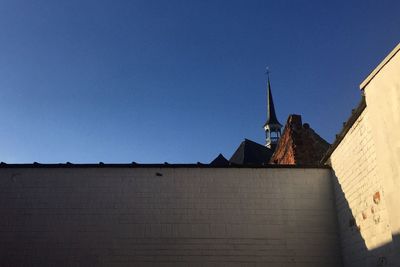 Low angle view of building against clear blue sky