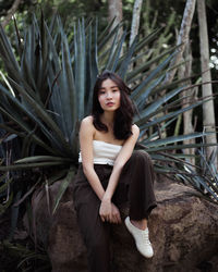 Portrait of young woman sitting outdoors