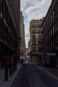 Street amidst buildings in city against sky