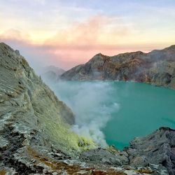 Smoke emitting from volcanic mountain against sky