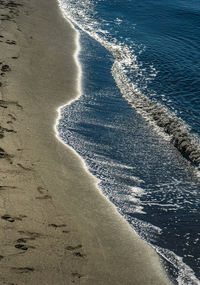 Black volcanic sand beach and waves of black sea on georgian shore in shevketili area