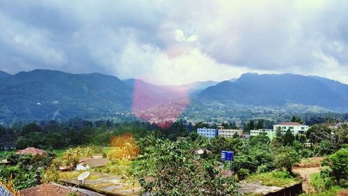 Scenic view of mountains against cloudy sky