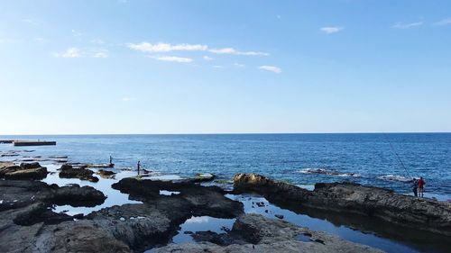 Scenic view of sea against blue sky