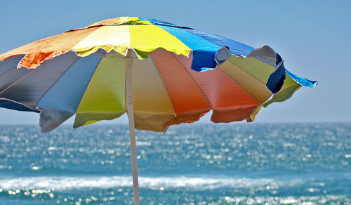 Colorful sunshade against sea