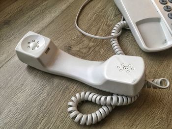 Close-up of telephone on wooden table