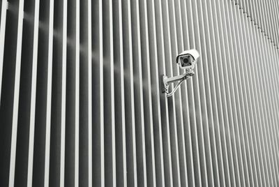 Full frame shot of metal grate against wall and monitor