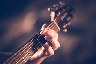 Cropped hand playing guitar