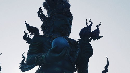 Low angle view of statue against sky