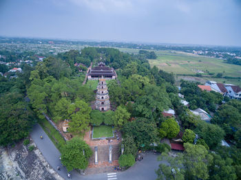 High angle view of buildings and trees against sky