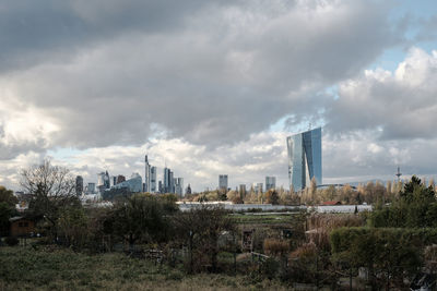 View of cityscape against cloudy sky