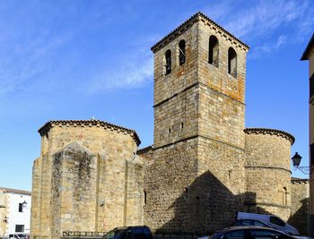 Low angle view of old building against blue sky