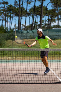 Rear view of man playing tennis