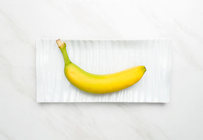 High angle view of yellow fruit on white table