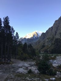 Scenic view of mountains against clear blue sky