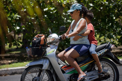 Side view of woman riding bicycle