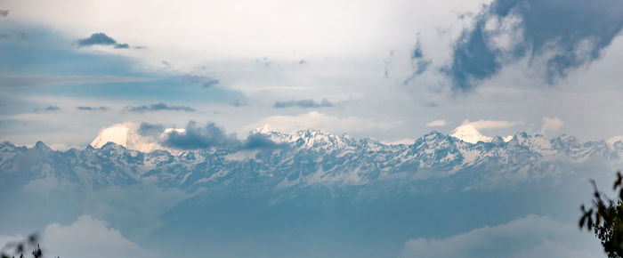 Low angle view of snowcapped mountains against sky