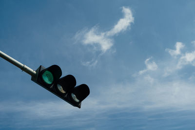 Low angle view of road sign against sky