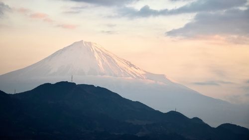 Scenic view of snowcapped mountains against sky during sunset