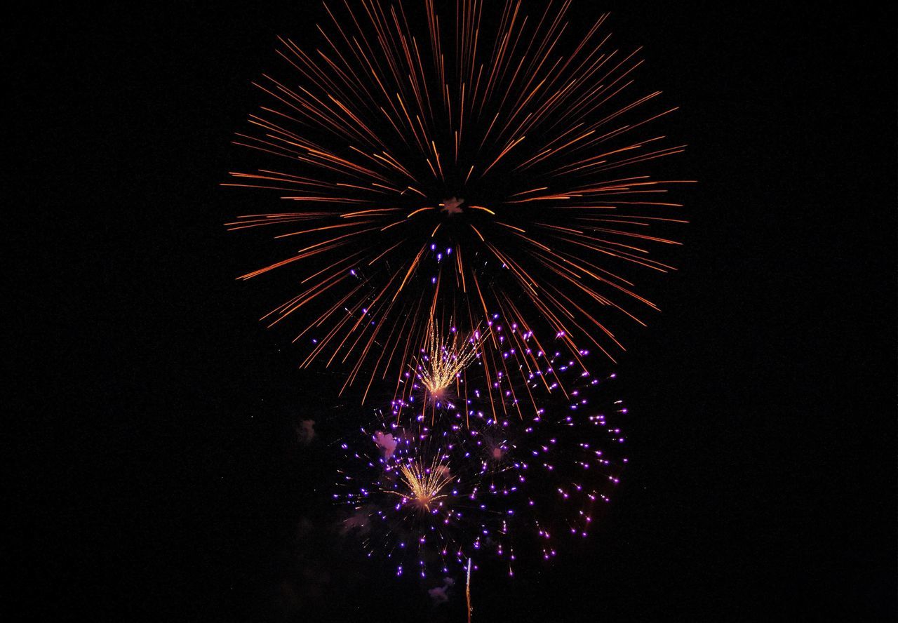 night, illuminated, firework display, celebration, exploding, low angle view, firework - man made object, arts culture and entertainment, glowing, event, motion, firework, sky, entertainment, celebration event, sparks, multi colored, light, dark, outdoors, no people, lit