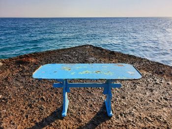 Empty beach object by sea against sky