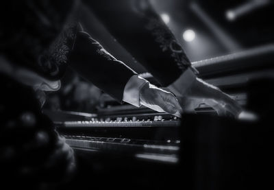 Midsection of man playing piano