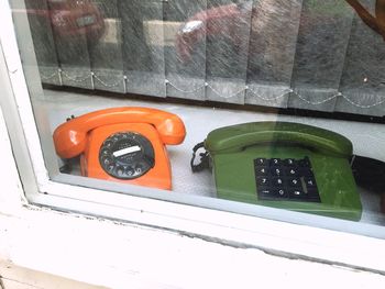 High angle view of telephone booth on glass