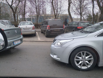 Cars parked on street in city