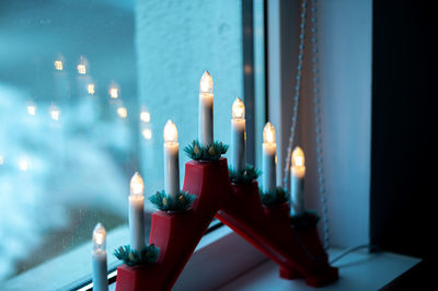 Advent electric candles on window sill