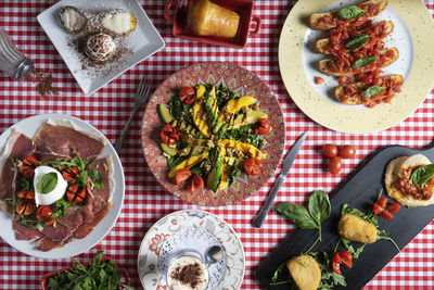 Panorama of italian food. various salad, skewer and dessert dishes.