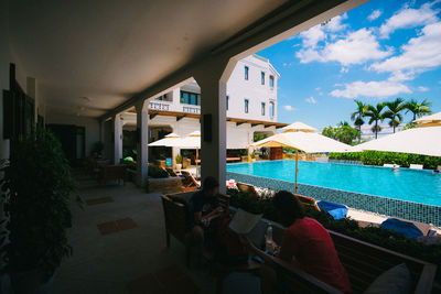 People in swimming pool against sky