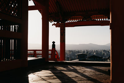 Silhouette of woman looking at view of building