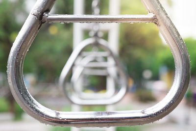 Close-up of metal railing in park