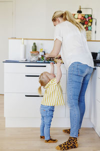 Mother with daughter in kitchen