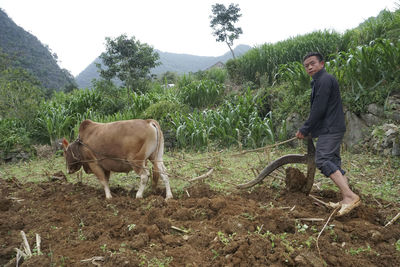 Side view of a young man standing on land