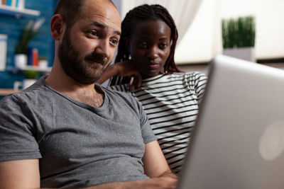 Couple working on laptop at home