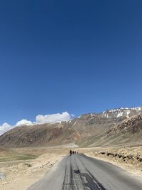 Road in desert against blue sky