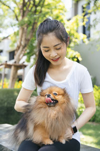 Portrait of woman holding dog